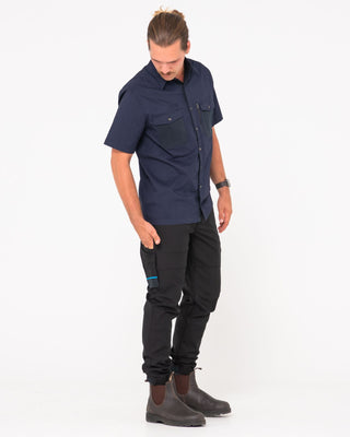 Man wearing Tr246 9 Pocket Stretch Work Pant Cuffed in Black