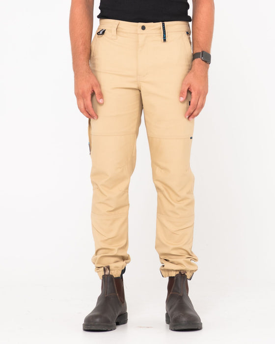 man-wearing-tr246-9-pocket-stretch-work-pant-cuffed-in-trade-khaki