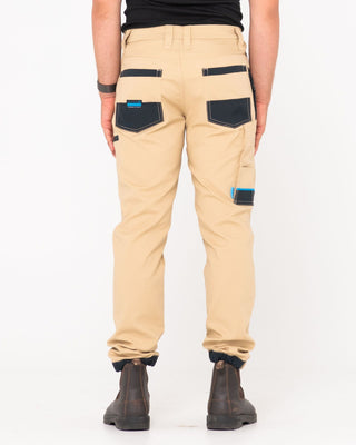 Man wearing Tr246 9 Pocket Stretch Work Pant Cuffed in Trade Khaki