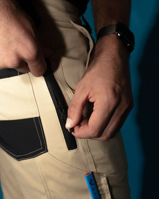 Man wearing Tr246 9 Pocket Stretch Work Pant Cuffed in Trade Khaki