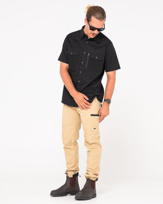 Man wearing Tr246 9 Pocket Stretch Work Pant Cuffed in Trade Khaki