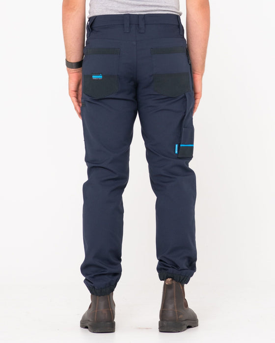 man-wearing-tr246-9-pocket-stretch-work-pant-cuffed-in-true-navy