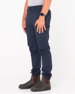 Man wearing Tr246 9 Pocket Stretch Work Pant Cuffed in True Navy