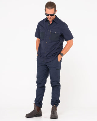 Man wearing Tr246 9 Pocket Stretch Work Pant Cuffed in True Navy