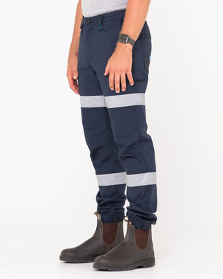 Man wearing Tr246r 9 Pkt Stretch Cuff Pant Reflect in True Navy