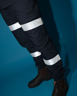 Man wearing Tr246r 9 Pkt Stretch Cuff Pant Reflect in True Navy