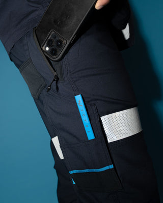 Man wearing Tr246r 9 Pkt Stretch Cuff Pant Reflect in True Navy