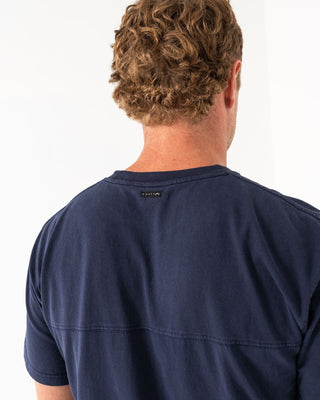 Man wearing Elbow Grease Short Sleeve Tee in Navy Blue