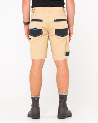Man wearing Tr400 9 Pocket Stretch Short in Trade Khaki