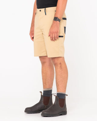 Man wearing Tr400 9 Pocket Stretch Short in Trade Khaki