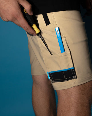 Man wearing Tr400 9 Pocket Stretch Short in Trade Khaki