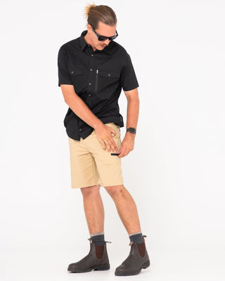 Man wearing Tr400 9 Pocket Stretch Short in Trade Khaki