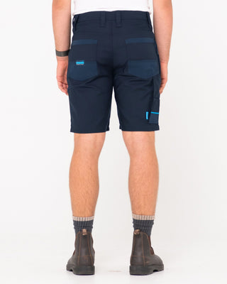 Man wearing Tr400 9 Pocket Stretch Short in True Navy