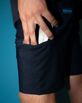 Man wearing Tr400 9 Pocket Stretch Short in True Navy