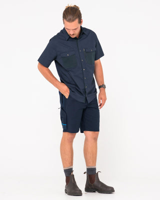 Man wearing Tr400 9 Pocket Stretch Short in True Navy