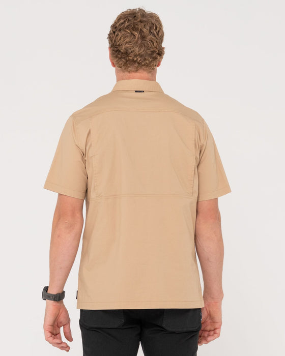 man-wearing-pressure-short-sleeve-shirt-in-khaki