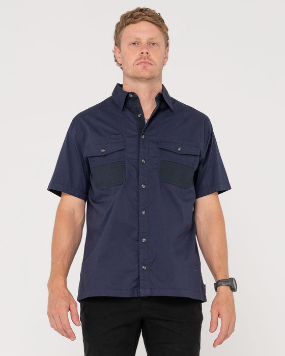 man-wearing-grindstones-short-sleeve-shirt-in-navy-blue