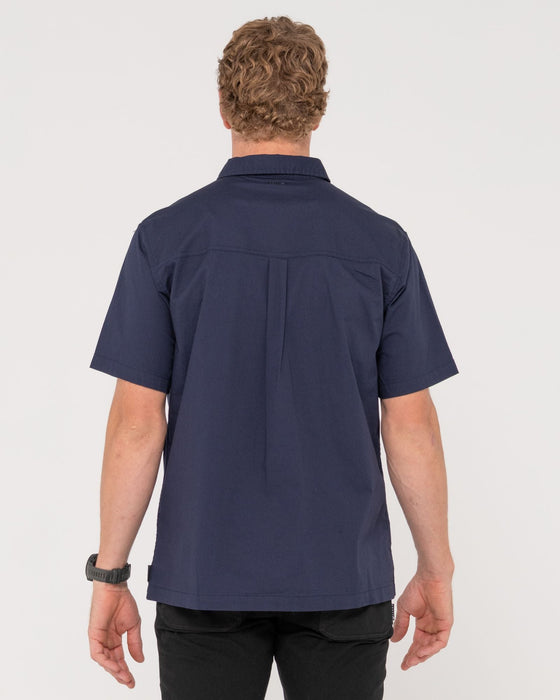 man-wearing-grindstones-short-sleeve-shirt-in-navy-blue