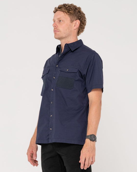man-wearing-grindstones-short-sleeve-shirt-in-navy-blue