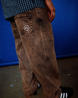 Man wearing R Dot Baggy Jean in Overdyed Brown