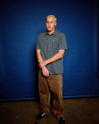 Man wearing R Dot Baggy Jean in Overdyed Brown