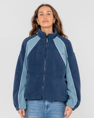 Woman wearing Two Tides Zip Through Sherpa Fleece in Atlantic Blue