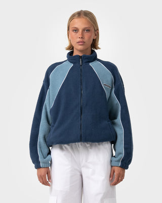 Woman wearing Two Tides Zip Through Sherpa Fleece in Atlantic Blue