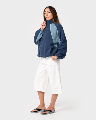 Woman wearing Two Tides Zip Through Sherpa Fleece in Atlantic Blue