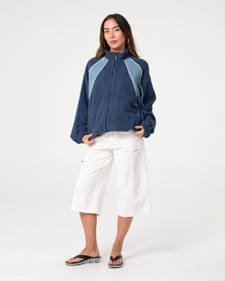 Woman wearing Two Tides Zip Through Sherpa Fleece in Atlantic Blue