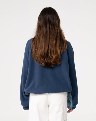 Woman wearing Two Tides Zip Through Sherpa Fleece in Atlantic Blue