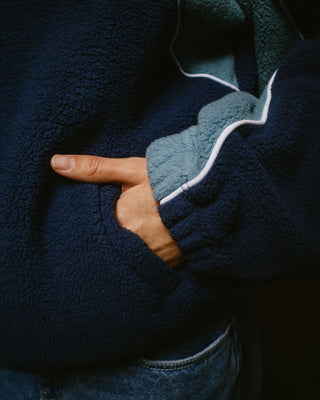 Woman wearing Two Tides Zip Through Sherpa Fleece in Atlantic Blue
