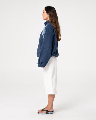 Woman wearing Two Tides Zip Through Sherpa Fleece in Atlantic Blue