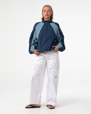Woman wearing Two Tides Zip Through Sherpa Fleece in Atlantic Blue