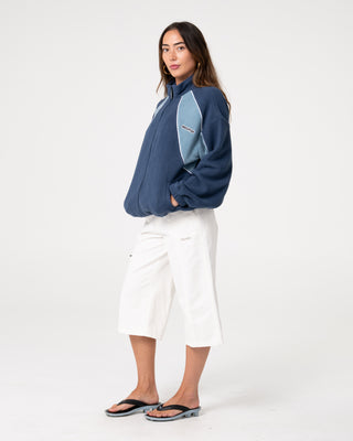 Woman wearing Two Tides Zip Through Sherpa Fleece in Atlantic Blue