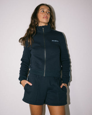 Woman wearing Midnights Long Sleeve Zip Through Fleece in Atlantic Blue