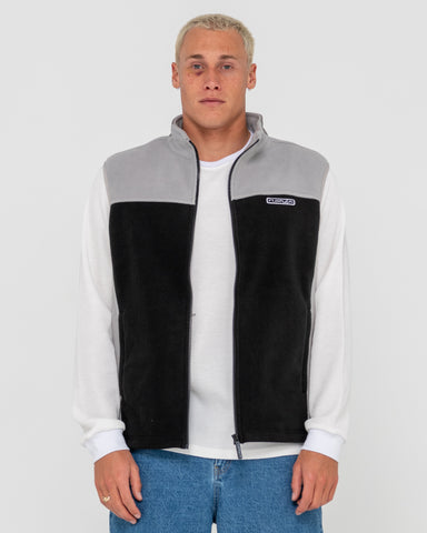 Man wearing On The Run Tech Fleece Vest in Black