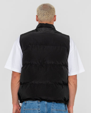 Man wearing Rippa Puffer Vest in Black