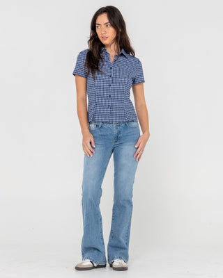 Woman wearing Betty Bootleg Low Rise Jean in Blasted Middy Blue