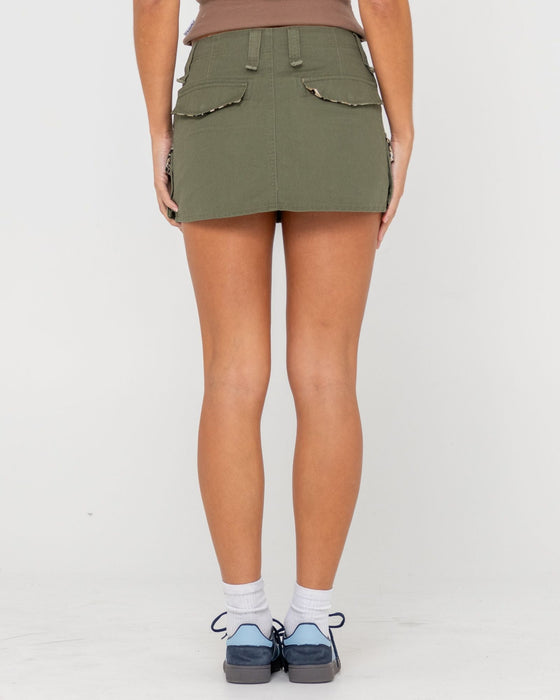 woman-wearing-tank-girl-low-rise-mini-skirt-in-shadow-army