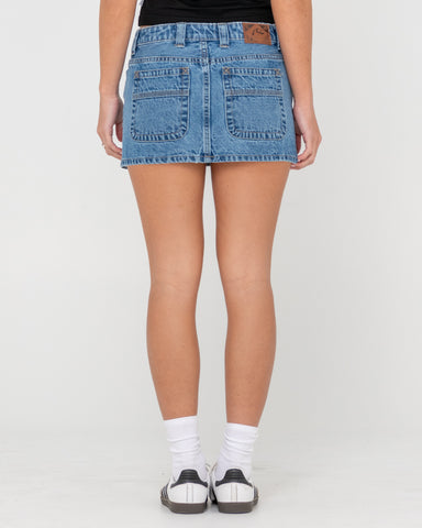 Woman wearing Mavericks Low Rise Denim Mini Skirt in Blue