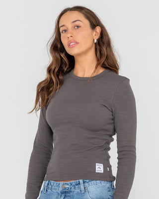 Woman wearing Rusty Essentials Ribbed Long Sleeve Tee in Carbon