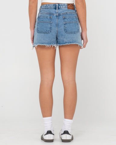 Woman wearing Penny Kick Flare Denim Short in Blue