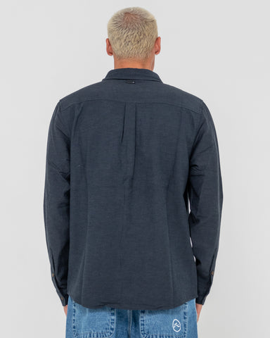 Man wearing Overtone Long Sleeve Linen Shirt in Blue