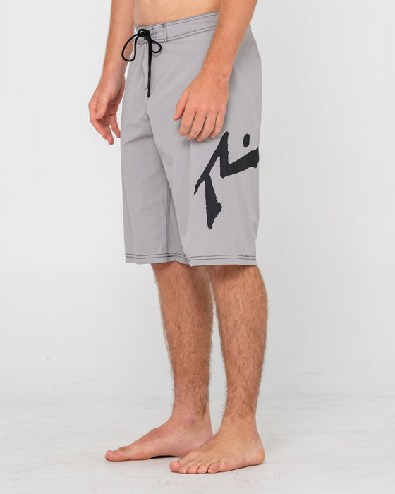 man-wearing-fixed-competition-revolution-boardshort-in-stone-grey