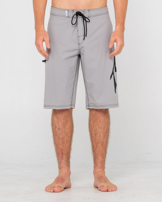 man-wearing-fixed-competition-revolution-boardshort-in-stone-grey