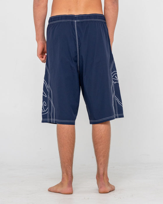 man-wearing-tombstones-hybrid-waist-boardshort-in-navy-blue