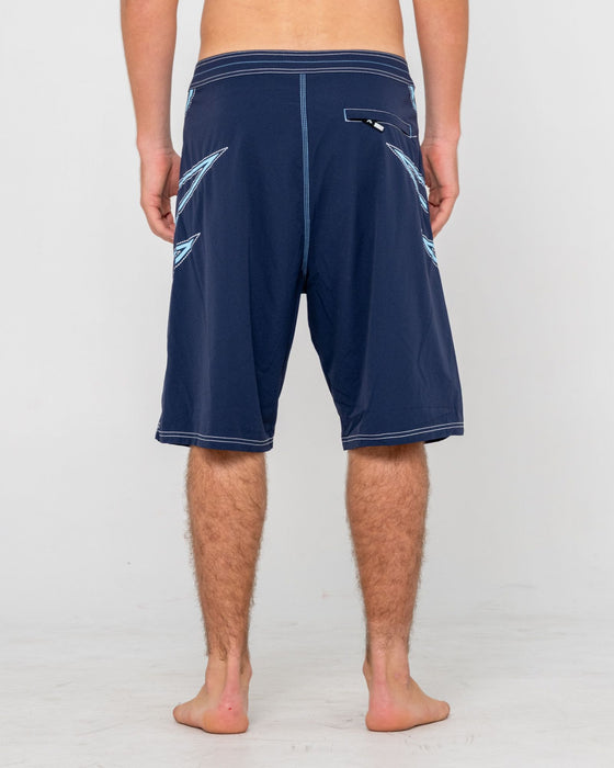 man-wearing-slasher-fixed-waist-boardshort-in-navy-blue