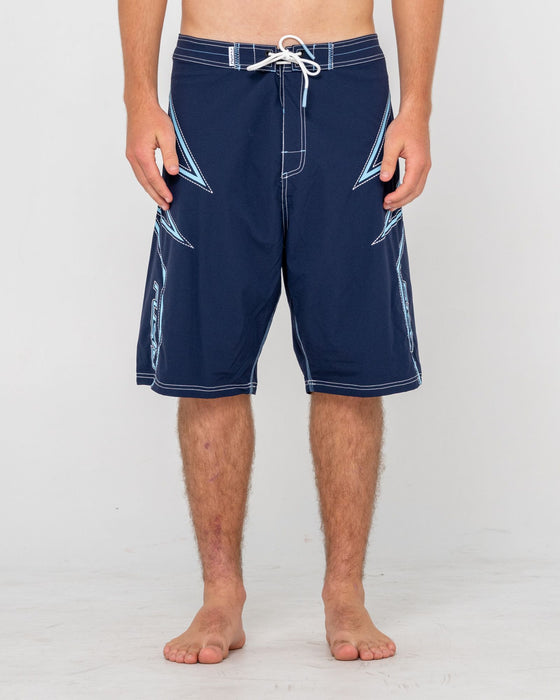 man-wearing-slasher-fixed-waist-boardshort-in-navy-blue