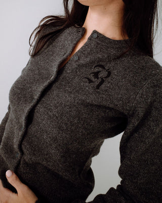 Woman wearing Rusty Academy Cardigan in Charcoal Marle