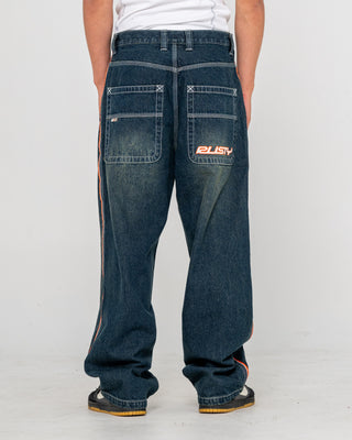 Man wearing Flip Daddy 2.0 Jean in Dark N Dirty / Orange